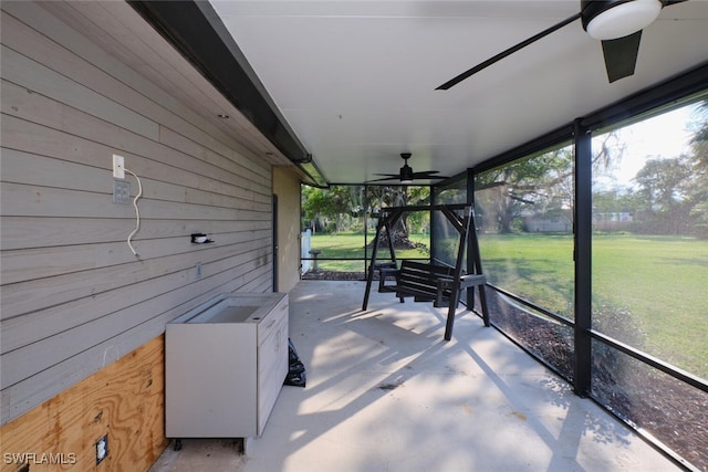 unfurnished sunroom featuring ceiling fan and a healthy amount of sunlight