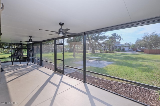 unfurnished sunroom with ceiling fan and a healthy amount of sunlight