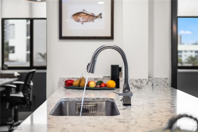 room details with light stone counters and sink