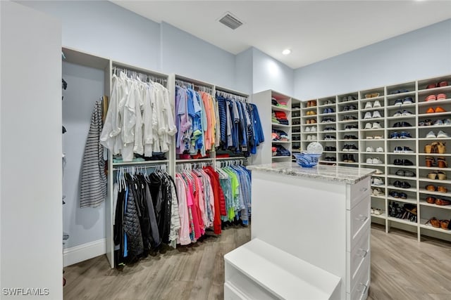 spacious closet featuring hardwood / wood-style flooring