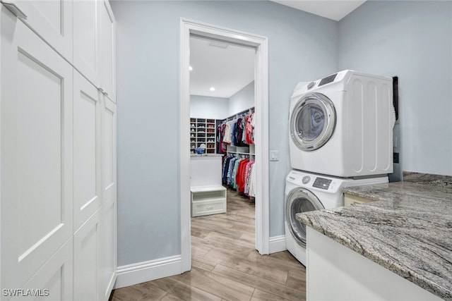 laundry area featuring stacked washer and clothes dryer