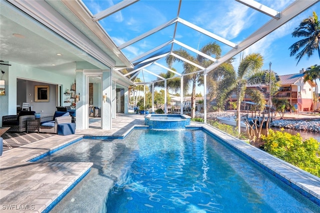 view of swimming pool featuring glass enclosure, outdoor lounge area, an in ground hot tub, and a patio