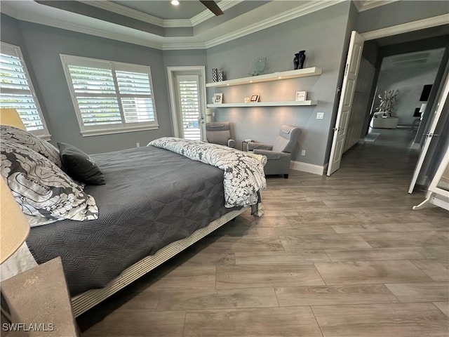 bedroom featuring ceiling fan, crown molding, and a raised ceiling