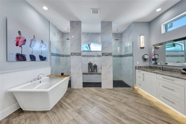 bathroom featuring separate shower and tub and vanity