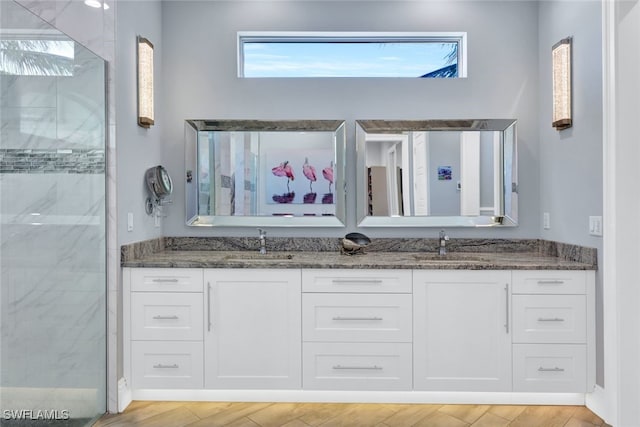 bathroom featuring a shower with shower door, vanity, and hardwood / wood-style flooring