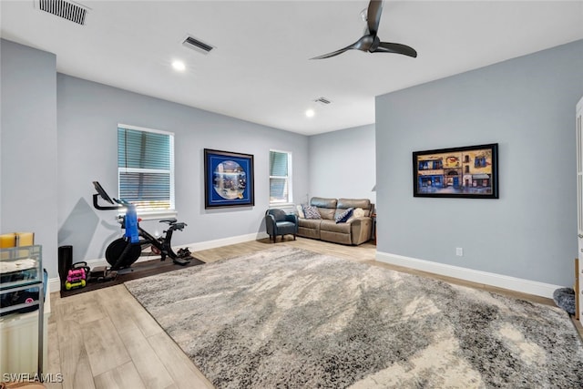 workout room with ceiling fan and hardwood / wood-style flooring