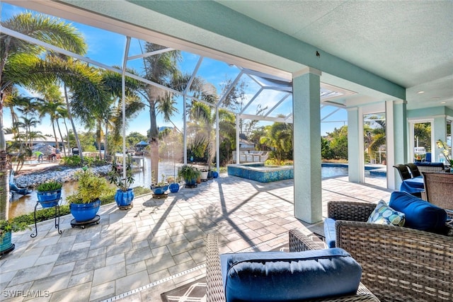 view of patio featuring a water view and glass enclosure