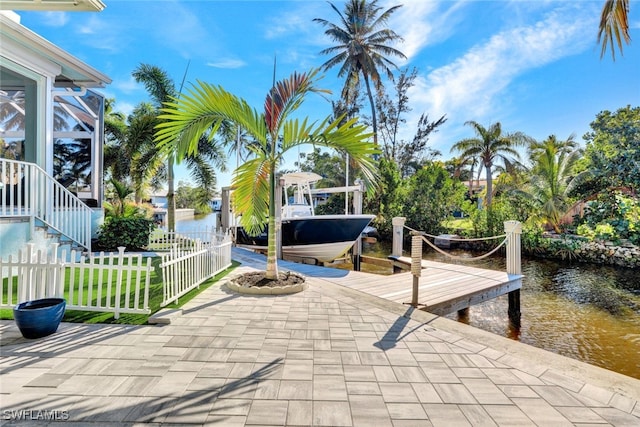 view of patio with a water view and a boat dock