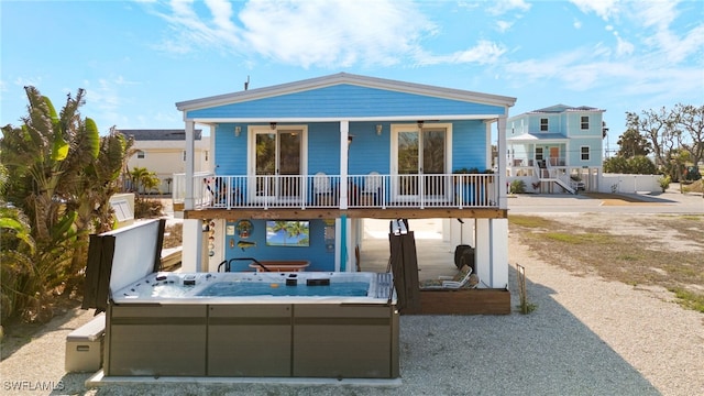261 Donora Blvd, Fort Myers Beach, FL 33931 - rear view of property featuring a hot tub and covered porch
