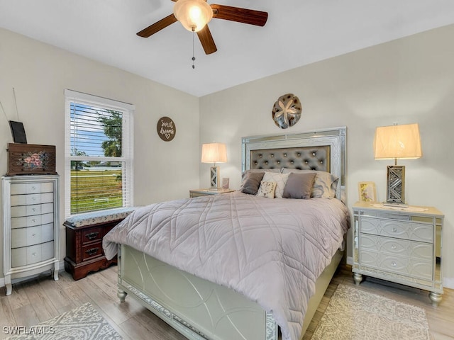 bedroom with ceiling fan and light wood-type flooring