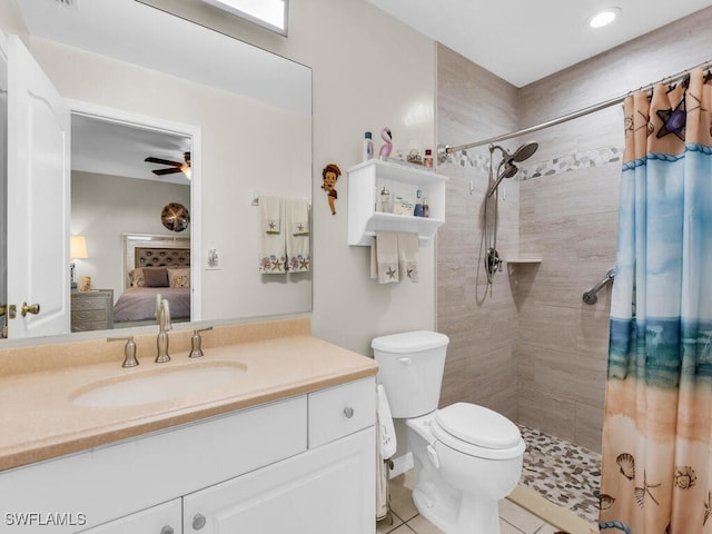 bathroom featuring walk in shower, vanity, ceiling fan, toilet, and tile patterned floors