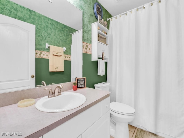 bathroom featuring tile patterned floors, vanity, and toilet