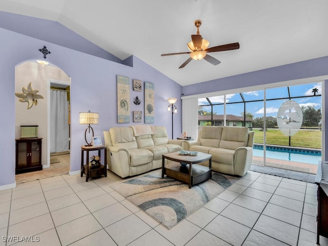 living room with ceiling fan, light tile patterned floors, and lofted ceiling