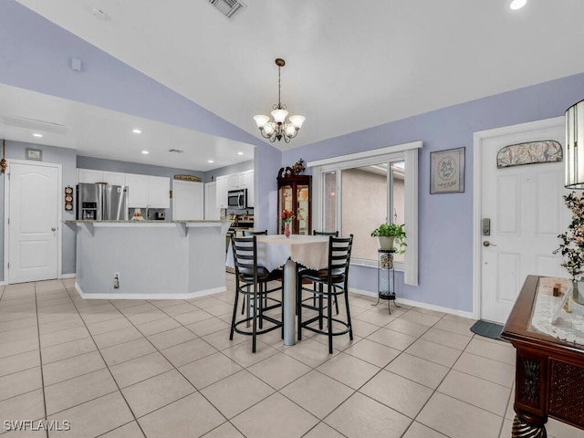 dining room with light tile patterned flooring, a chandelier, and vaulted ceiling