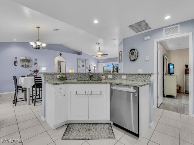 kitchen featuring an island with sink, stainless steel dishwasher, ceiling fan with notable chandelier, white cabinets, and sink