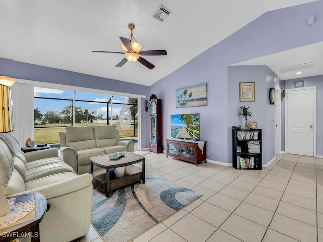 living room featuring ceiling fan, light tile patterned floors, and vaulted ceiling