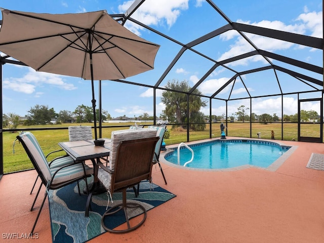 view of pool with glass enclosure, a yard, and a patio