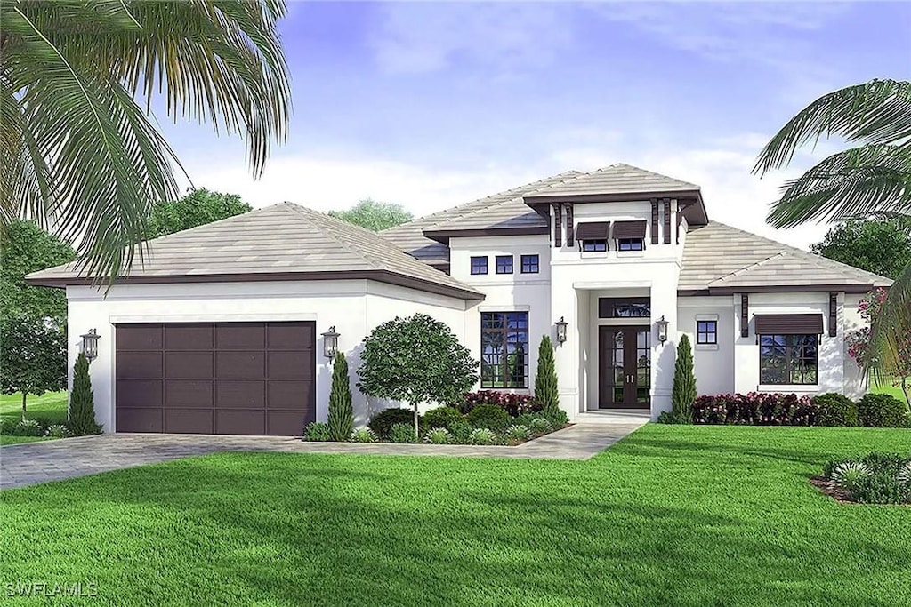 view of front of home featuring french doors, a front yard, and a garage