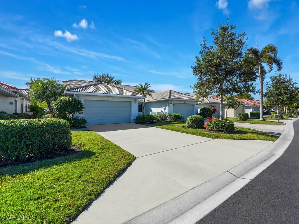 ranch-style house with a garage and a front yard