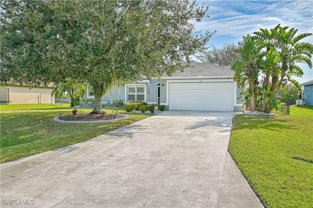 obstructed view of property featuring a garage and a front lawn