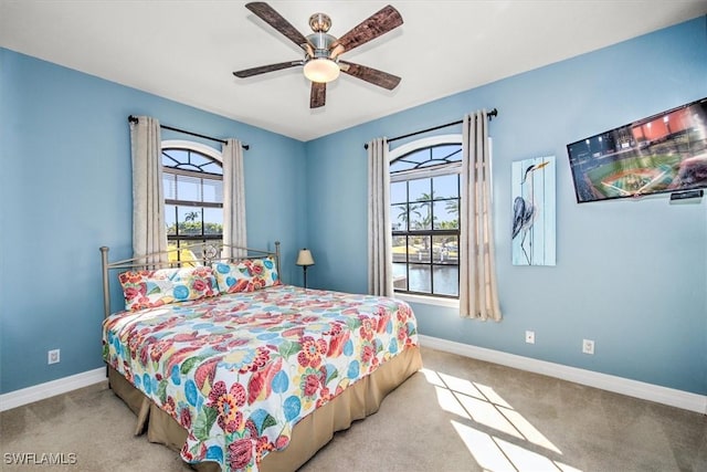 bedroom featuring light colored carpet and ceiling fan