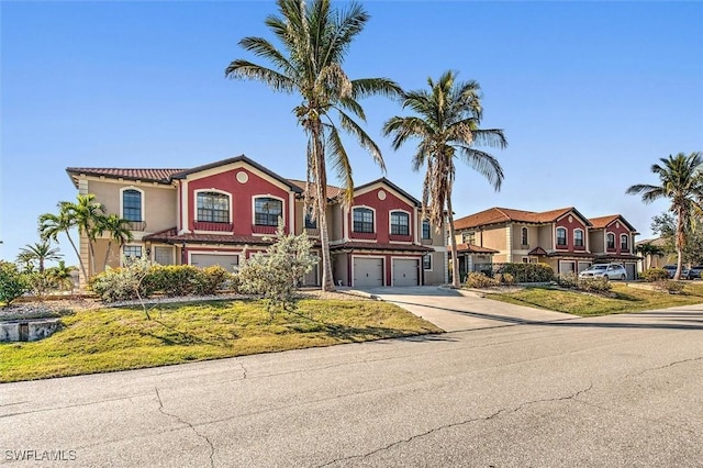 view of front of property featuring a garage and a front lawn