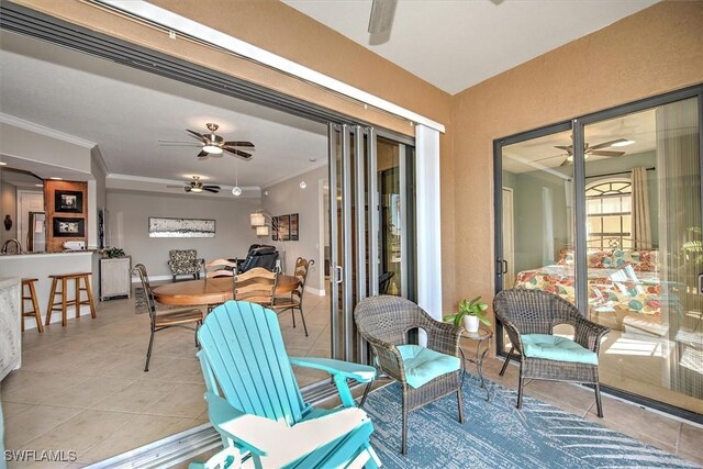 sunroom featuring ceiling fan