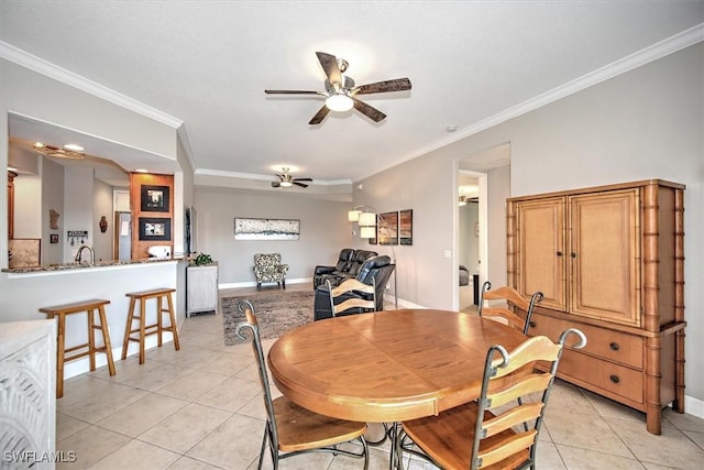 dining room featuring crown molding, sink, light tile patterned floors, and ceiling fan