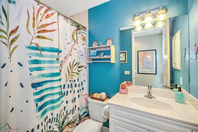 bathroom featuring vanity, toilet, and a shower with shower curtain