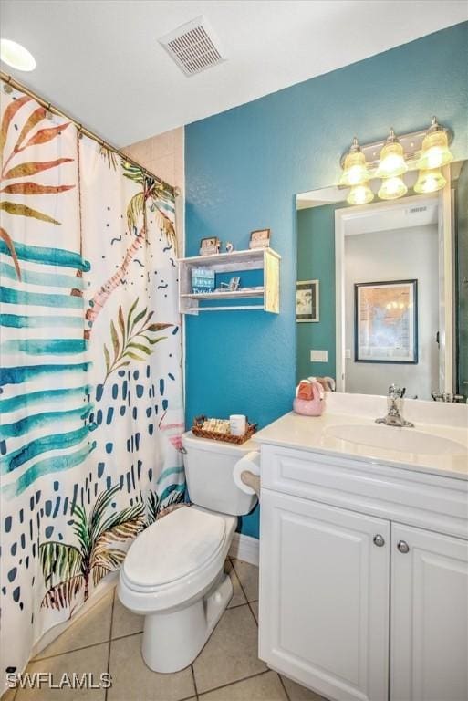 bathroom featuring tile patterned flooring, vanity, walk in shower, and toilet