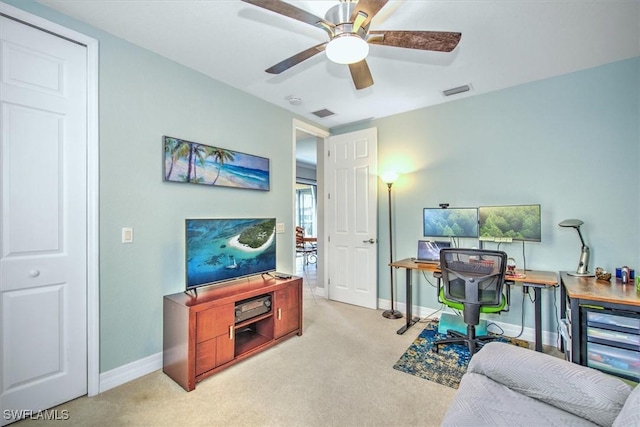 home office featuring light colored carpet and ceiling fan