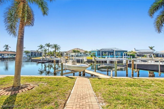 dock area with a water view and a yard