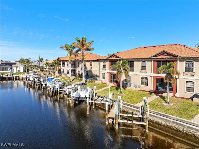 dock area featuring a water view and a lawn