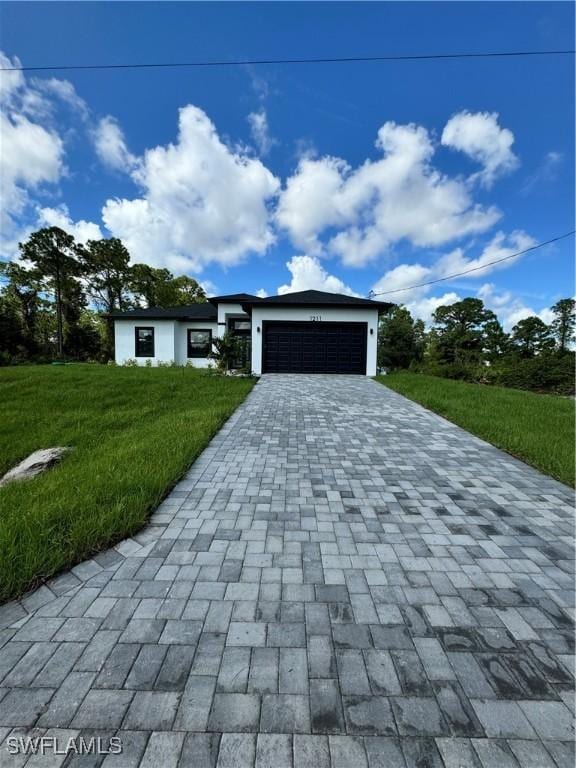 view of front of house with a front lawn and a garage