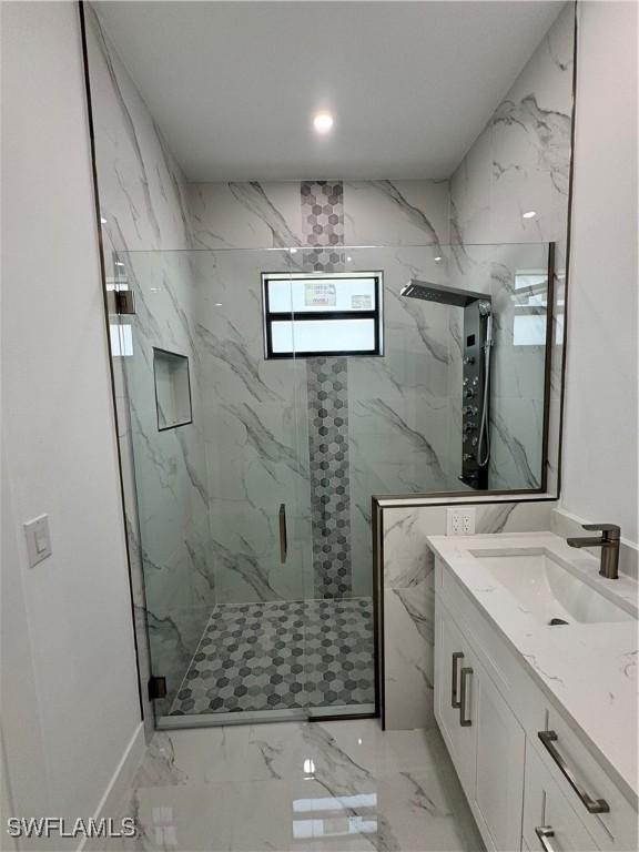 bathroom featuring an enclosed shower and vanity