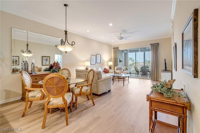 dining room with ceiling fan, crown molding, and light hardwood / wood-style flooring