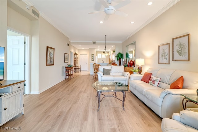 living room with ceiling fan, crown molding, and light hardwood / wood-style floors