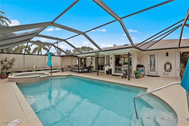 view of pool featuring a lanai, a patio, and an in ground hot tub