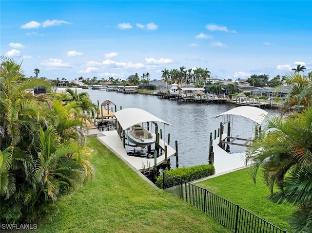 dock area with a water view and a lawn