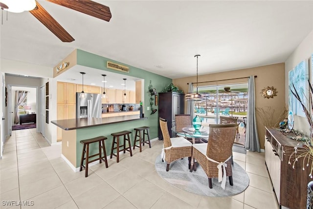 tiled dining room featuring ceiling fan