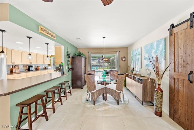 tiled dining area with a barn door