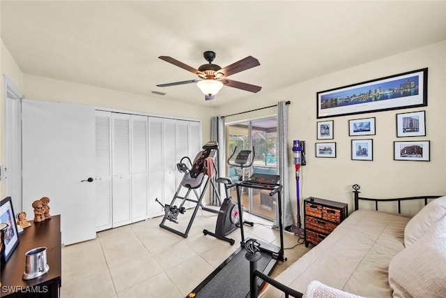 bedroom with ceiling fan, a closet, and light tile patterned flooring