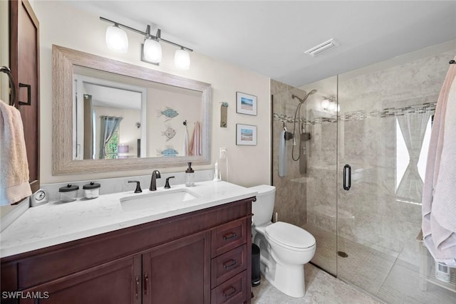 bathroom with toilet, a shower with shower door, and vanity