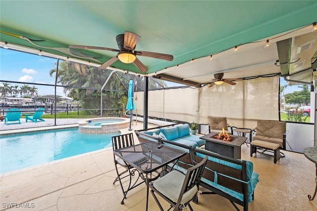 view of swimming pool with an outdoor living space with a fire pit, a patio area, and an in ground hot tub