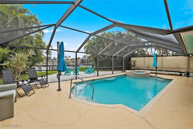 view of swimming pool with a lanai, a patio area, and an in ground hot tub