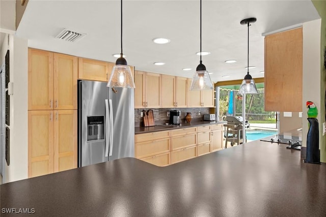 kitchen featuring decorative backsplash, stainless steel fridge with ice dispenser, light brown cabinets, and pendant lighting