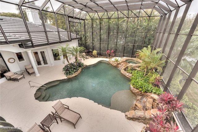 view of pool featuring a lanai, french doors, a hot tub, and a patio area