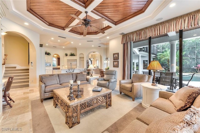 living room with ceiling fan, wood ceiling, plenty of natural light, and crown molding