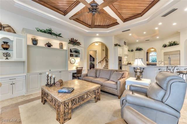 tiled living room featuring ceiling fan, ornamental molding, and wood ceiling