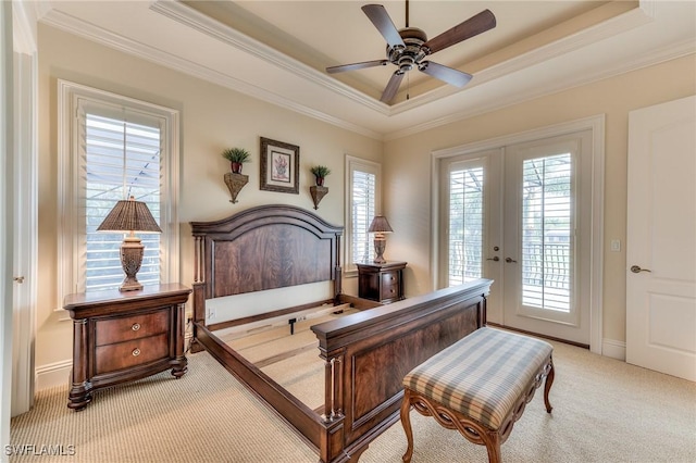 carpeted bedroom featuring ceiling fan, access to outside, a raised ceiling, ornamental molding, and french doors